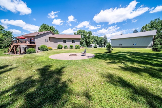 1322 Frontier Rd SE, Salem Twp, MN 55920 - view of grassy yard featuring stairs, a wooden deck, an outdoor fire pit, and a patio