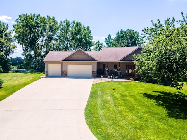 1322 Frontier Rd SE, Salem Twp, MN 55920 - view of front facade featuring an attached garage, driveway, a front yard, and stone siding