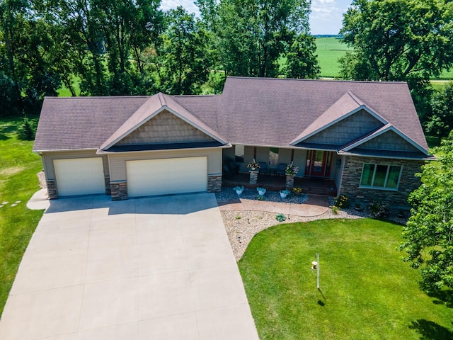 1322 Frontier Rd SE, Salem Twp, MN 55920 - craftsman inspired home featuring stone siding, an attached garage, a porch, a front lawn, and concrete driveway