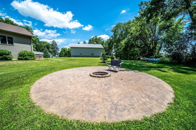 1322 Frontier Rd SE, Salem Twp, MN 55920 - view of grassy yard with an outdoor fire pit and a patio