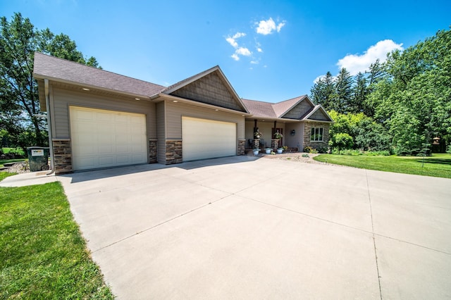 1322 Frontier Rd SE, Salem Twp, MN 55920 - view of front of home featuring a garage, driveway, a front lawn, stone siding, and a porch