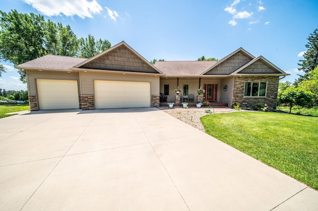 1322 Frontier Rd SE, Salem Twp, MN 55920 - craftsman house with stone siding, a garage, covered porch, a front lawn, and concrete driveway