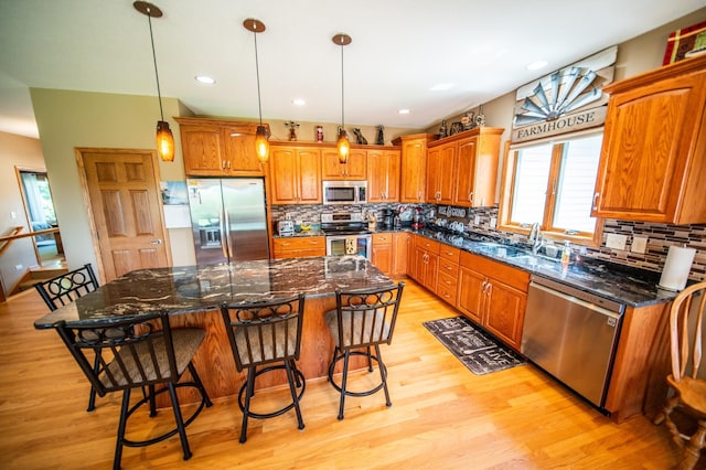 1322 Frontier Rd SE, Salem Twp, MN 55920 - kitchen with appliances with stainless steel finishes, healthy amount of natural light, light wood finished floors, brown cabinets, and recessed lighting