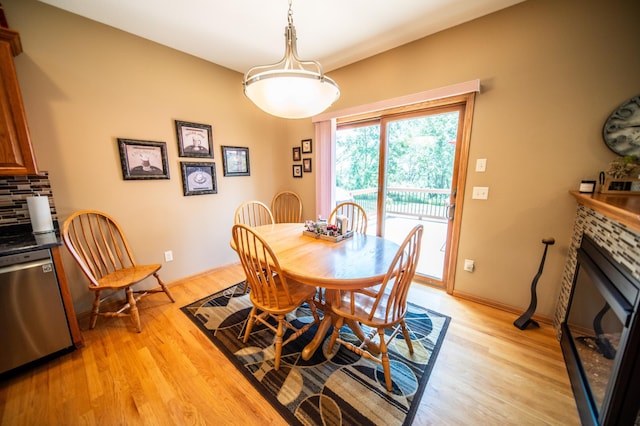 1322 Frontier Rd SE, Salem Twp, MN 55920 - dining space with light wood-type flooring and a fireplace