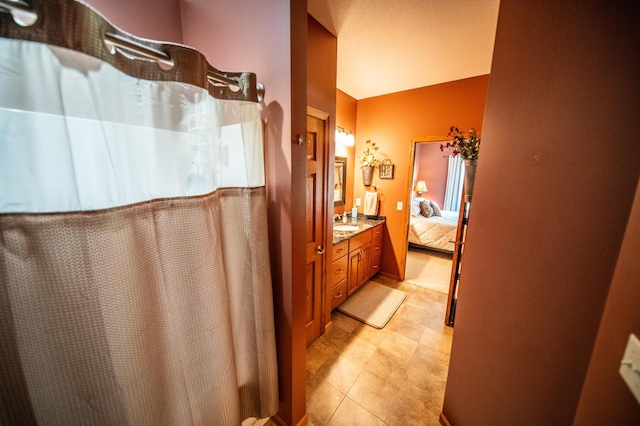 1322 Frontier Rd SE, Salem Twp, MN 55920 - bathroom with vanity, connected bathroom, a shower with shower curtain, and tile patterned floors