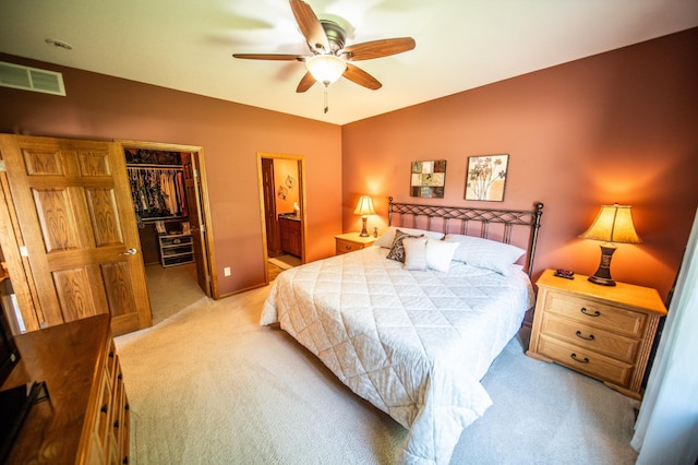 1322 Frontier Rd SE, Salem Twp, MN 55920 - carpeted bedroom featuring lofted ceiling, a walk in closet, a closet, ensuite bath, and a ceiling fan