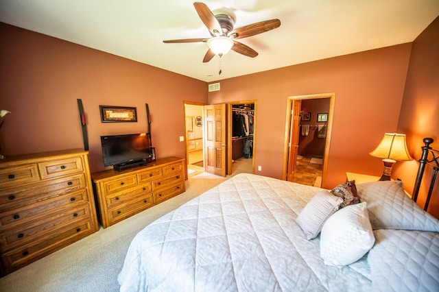 1322 Frontier Rd SE, Salem Twp, MN 55920 - carpeted bedroom featuring a walk in closet, a closet, ensuite bath, and ceiling fan