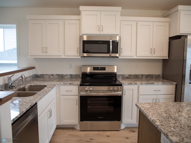 7891 Lost River Rd, Horace, ND 58047 - kitchen with appliances with stainless steel finishes and white cabinets