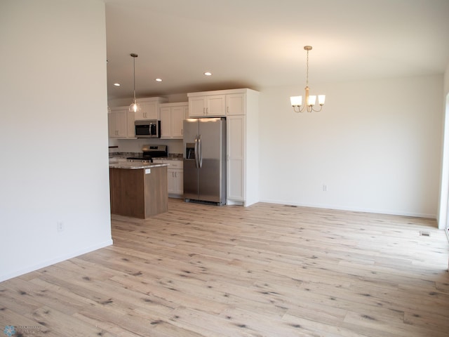 7891 Lost River Rd, Horace, ND 58047 - kitchen featuring stainless steel appliances, a chandelier, light wood-type flooring, recessed lighting, and hanging light fixtures