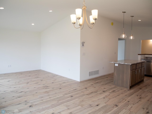 7891 Lost River Rd, Horace, ND 58047 - kitchen featuring light wood-style floors, lofted ceiling, a kitchen island, open floor plan, and decorative light fixtures