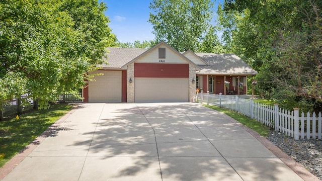 6961 Meadow Ct, Centerville, MN 55038 - view of front facade with an attached garage, driveway, brick siding, and roof with shingles