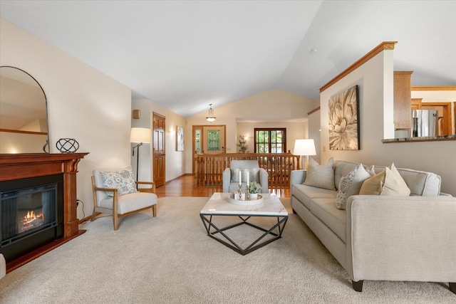 6961 Meadow Ct, Centerville, MN 55038 - living room featuring vaulted ceiling, a glass covered fireplace, and carpet flooring