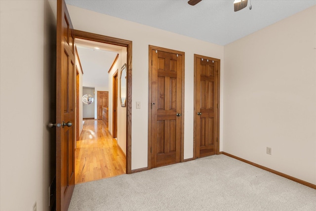 6961 Meadow Ct, Centerville, MN 55038 - unfurnished bedroom with two closets, light carpet, and a ceiling fan