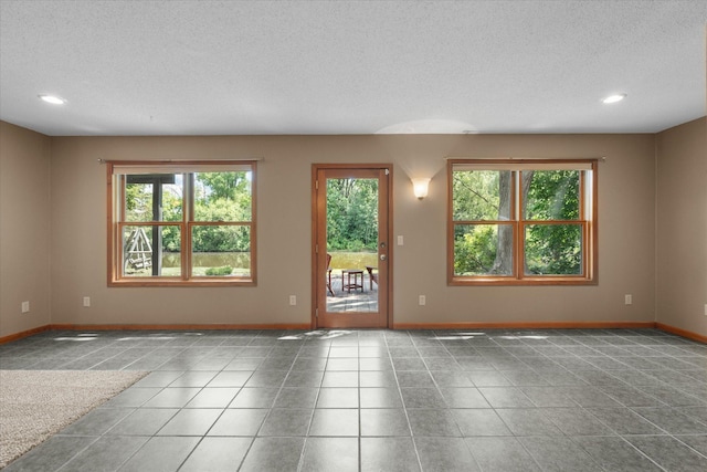 6961 Meadow Ct, Centerville, MN 55038 - empty room featuring a textured ceiling, recessed lighting, and tile patterned floors