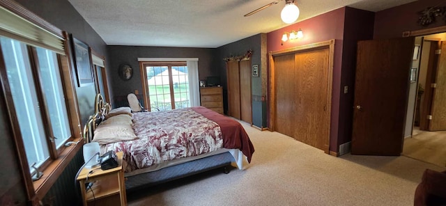 2473 Marshall St, Albert Lea, MN 56007 - bedroom with carpet flooring, a textured ceiling, a ceiling fan, and access to exterior