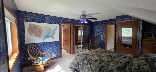 2473 Marshall St, Albert Lea, MN 56007 - bedroom featuring wallpapered walls, vaulted ceiling, carpet floors, a textured ceiling, and ceiling fan