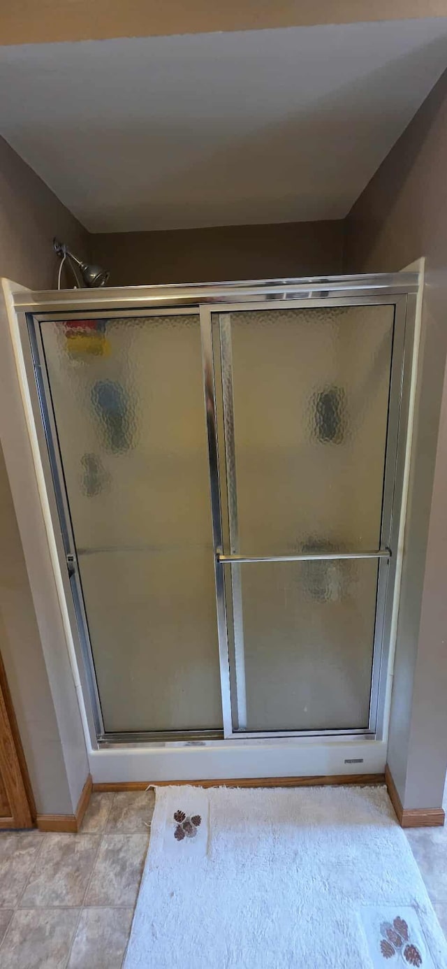 2473 Marshall St, Albert Lea, MN 56007 - full bathroom featuring baseboards and a shower stall
