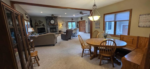 2473 Marshall St, Albert Lea, MN 56007 - dining space with light colored carpet, a ceiling fan, a stone fireplace, and recessed lighting