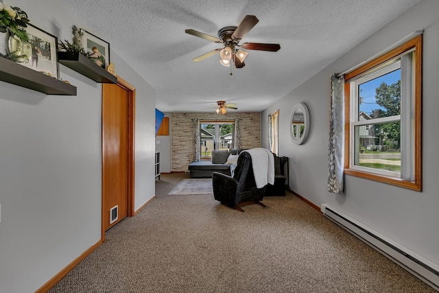 216 1st St SW, Melrose, MN 56352 - carpeted living room with a baseboard radiator, ceiling fan, and a textured ceiling