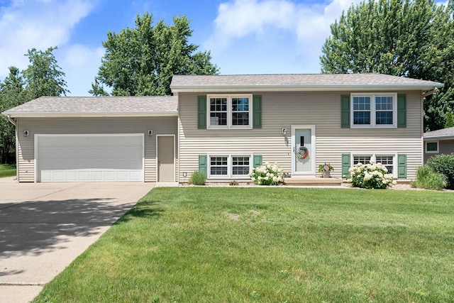 1602 19th Ave SW, Austin, MN 55912 - raised ranch featuring concrete driveway, an attached garage, and a front lawn