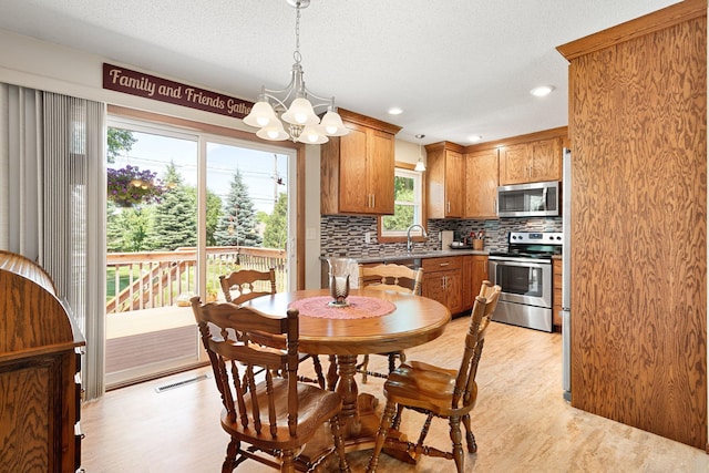 1602 19th Ave SW, Austin, MN 55912 - dining space featuring a chandelier, light wood finished floors, recessed lighting, and a textured ceiling
