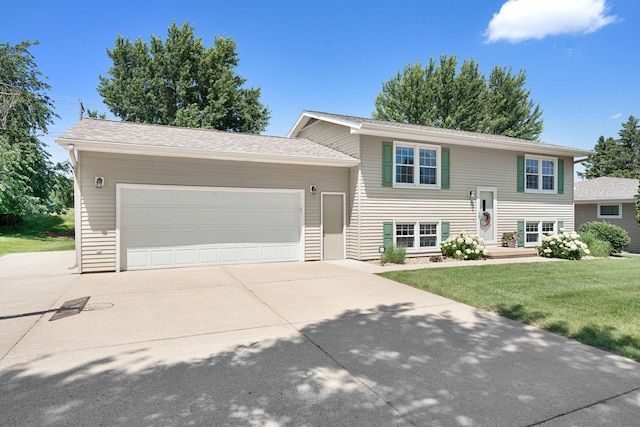 1602 19th Ave SW, Austin, MN 55912 - bi-level home with concrete driveway, an attached garage, and a front lawn