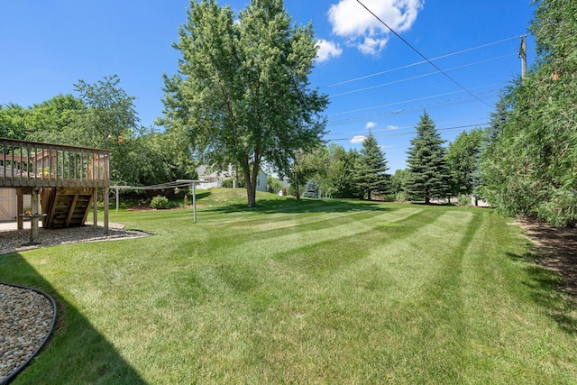 1602 19th Ave SW, Austin, MN 55912 - view of green lawn with stairway and a wooden deck