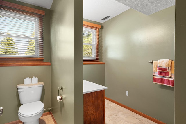 1602 19th Ave SW, Austin, MN 55912 - half bathroom featuring vanity and a textured ceiling