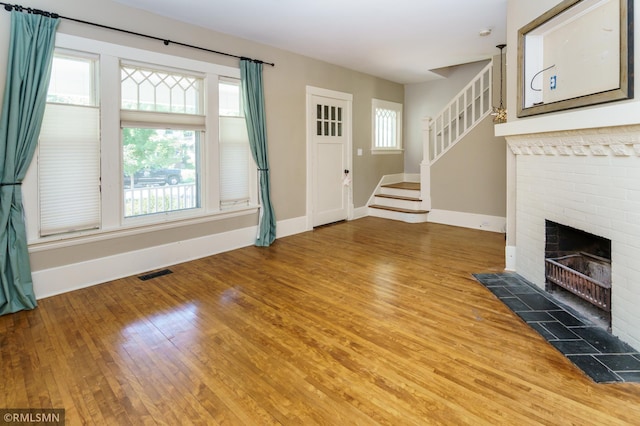 4709 Colfax Ave S, Minneapolis, MN 55419 - unfurnished living room with wood finished floors, healthy amount of natural light, and a brick fireplace