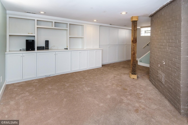 4709 Colfax Ave S, Minneapolis, MN 55419 - basement with light colored carpet, brick wall, stairway, and recessed lighting