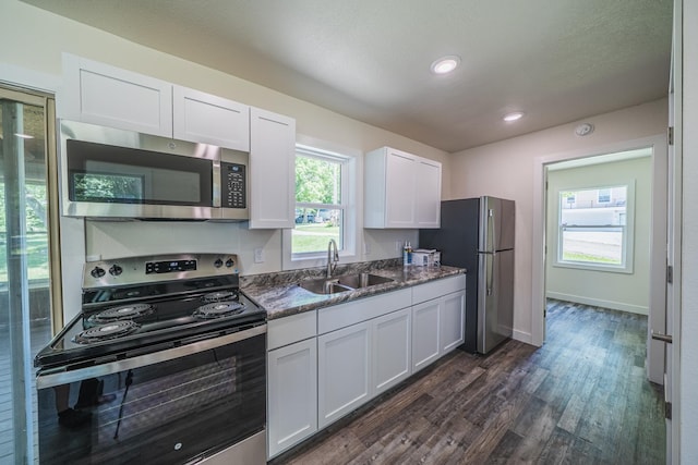 29501 Maplewood Rd Longshore, Unit Longshore, Callaway, MN 56521 - kitchen with appliances with stainless steel finishes, dark wood-style flooring, white cabinets, dark stone countertops, and recessed lighting