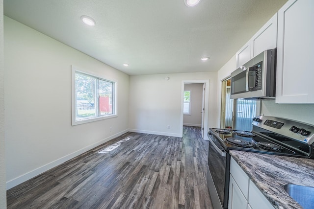 29501 Maplewood Rd Longshore, Unit Longshore, Callaway, MN 56521 - kitchen with stainless steel appliances, dark wood-type flooring, white cabinets, dark stone countertops, and recessed lighting