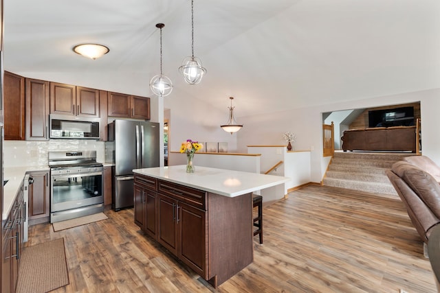 818 Myrtle St, Buffalo, MN 55313 - kitchen with stainless steel appliances, open floor plan, tasteful backsplash, light countertops, and a kitchen island