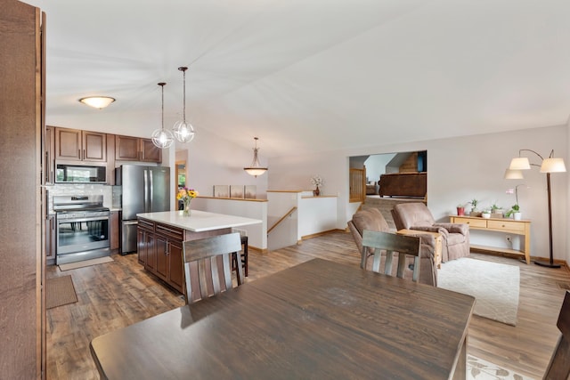 818 Myrtle St, Buffalo, MN 55313 - dining area with lofted ceiling and dark wood-style flooring