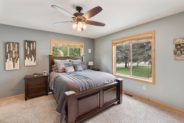 818 Myrtle St, Buffalo, MN 55313 - bedroom featuring multiple windows, light colored carpet, and ceiling fan
