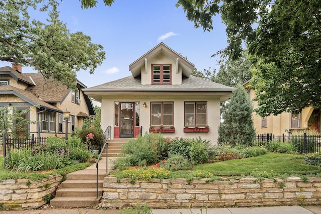 5043 Nokomis Ave, Minneapolis, MN 55417 - bungalow-style home featuring stucco siding, a porch, and a shingled roof