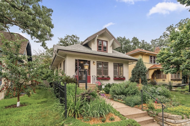 5043 Nokomis Ave, Minneapolis, MN 55417 - bungalow-style home with stucco siding, covered porch, and roof with shingles