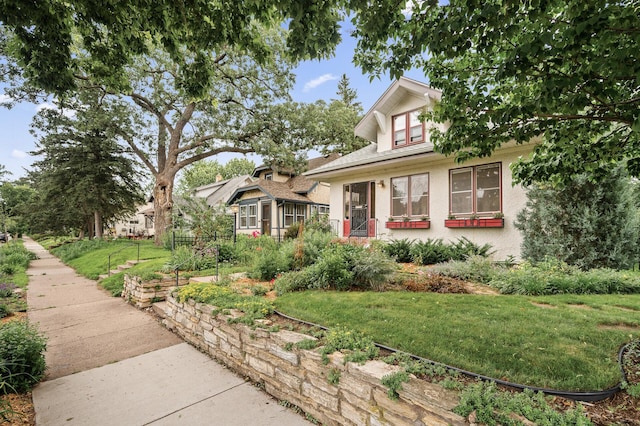 5043 Nokomis Ave, Minneapolis, MN 55417 - bungalow-style home with a front yard and stucco siding