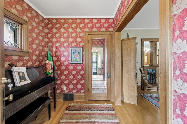 5043 Nokomis Ave, Minneapolis, MN 55417 - foyer entrance with wood finished floors, crown molding, and wallpapered walls