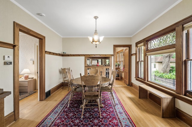 5043 Nokomis Ave, Minneapolis, MN 55417 - dining space with a chandelier, light wood finished floors, and ornamental molding