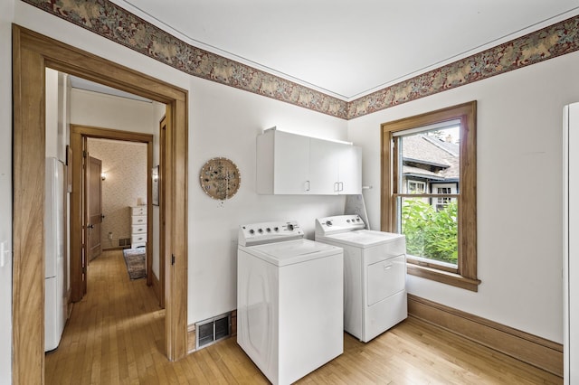 5043 Nokomis Ave, Minneapolis, MN 55417 - laundry room with independent washer and dryer, light wood-style floors, and cabinet space