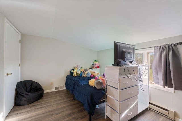 4069 Dublin Rd, Hibbing, MN 55746 - bedroom featuring a baseboard heating unit, wood finished floors, and vaulted ceiling