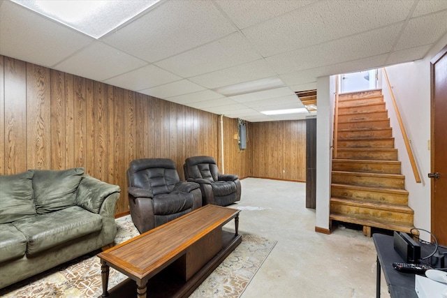 4069 Dublin Rd, Hibbing, MN 55746 - living room with a drop ceiling, wooden walls, stairs, and concrete floors
