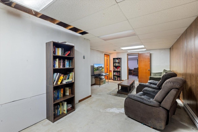 4069 Dublin Rd, Hibbing, MN 55746 - living area with baseboard heating, unfinished concrete flooring, and wooden walls