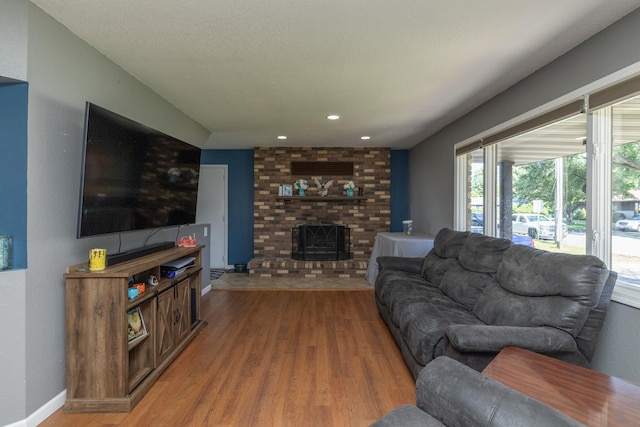 1478 Walnut St, Prescott, WI 54021 - living room featuring light wood-type flooring, a brick fireplace, and recessed lighting