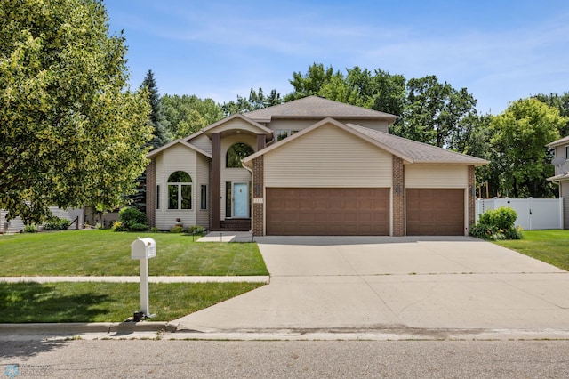 525 20 1/2 Ave E, West Fargo, ND 58078 - view of front of house featuring an attached garage, driveway, and brick siding