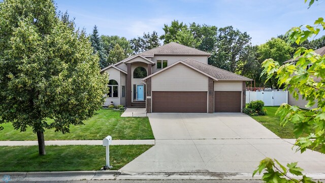 525 20 1/2 Ave E, West Fargo, ND 58078 - traditional-style home featuring a garage, driveway, and brick siding