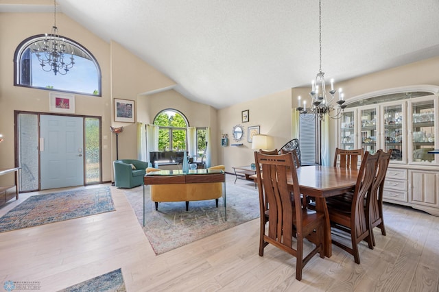 525 20 1/2 Ave E, West Fargo, ND 58078 - dining space featuring a chandelier, light wood-style floors, and high vaulted ceiling