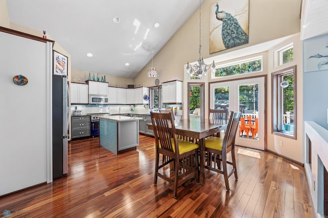 525 20 1/2 Ave E, West Fargo, ND 58078 - dining area with high vaulted ceiling, dark wood-style floors, french doors, and recessed lighting