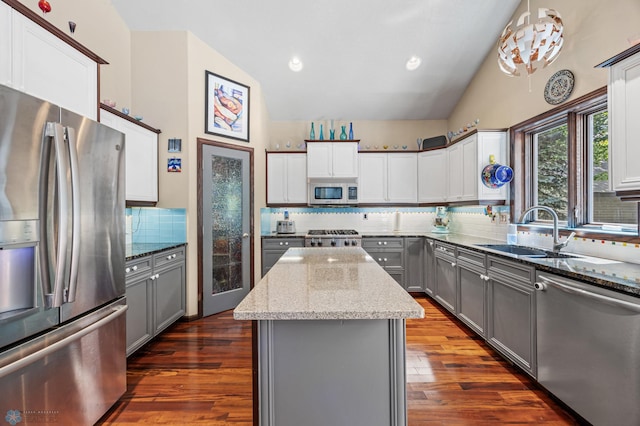 525 20 1/2 Ave E, West Fargo, ND 58078 - kitchen with appliances with stainless steel finishes, gray cabinetry, decorative backsplash, light stone countertops, and high vaulted ceiling